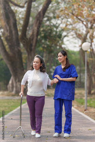 Healthcare nurse, physical therapy with elderly woman at outdoor. Nurse holding hand and help elderly woman walking