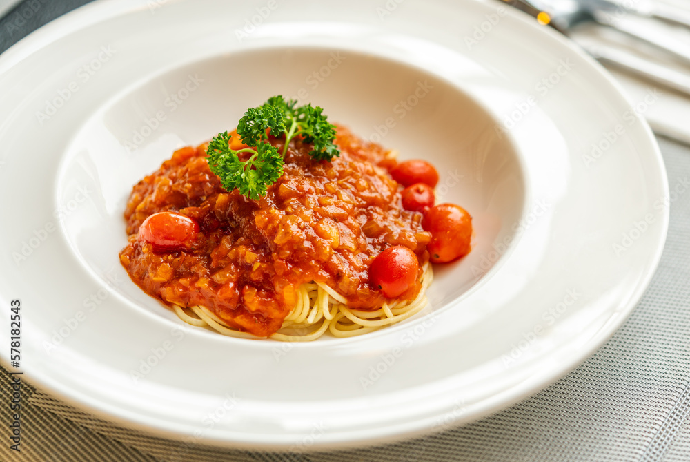 Spaghetti with tomato sauce and minced pork. Spaghetti with tomato sauce in white beautiful dish, natural light from window. Spaghetti with tomato sauce and minced pork. Spaghetti with tomato sauce in white beautiful dish, natural light from window.