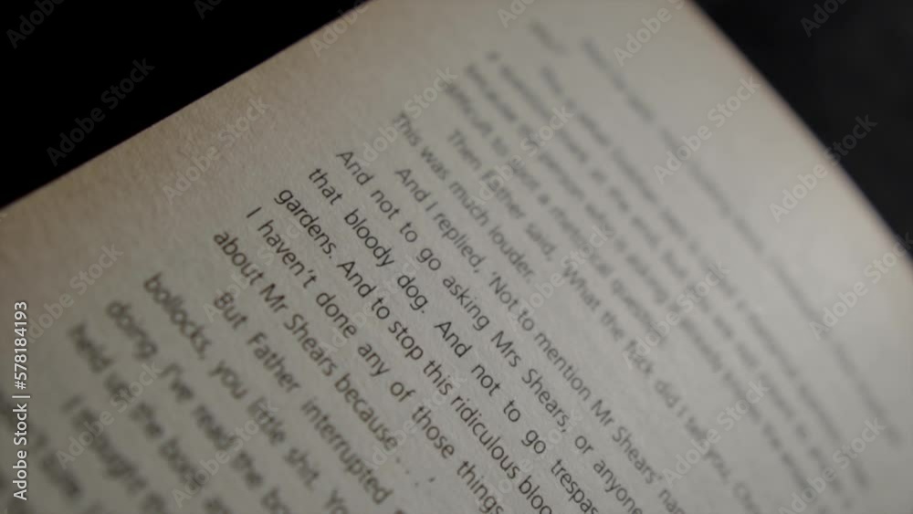 Macro closeup of text page in a book, slide down soft focus to right side Macro closeup of text page in a book, slide down soft focus to right side