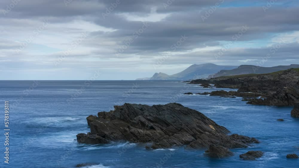 Timelapse of rugged coastline with moving clouds on sunny day in Cloughmore Bay in Achill Island in county Mayo along the Wild Atlantic Way. Timelapse of rugged coastline with moving clouds on sunny day in Cloughmore Bay in Achill Island in county Mayo along the Wild Atlantic Way.