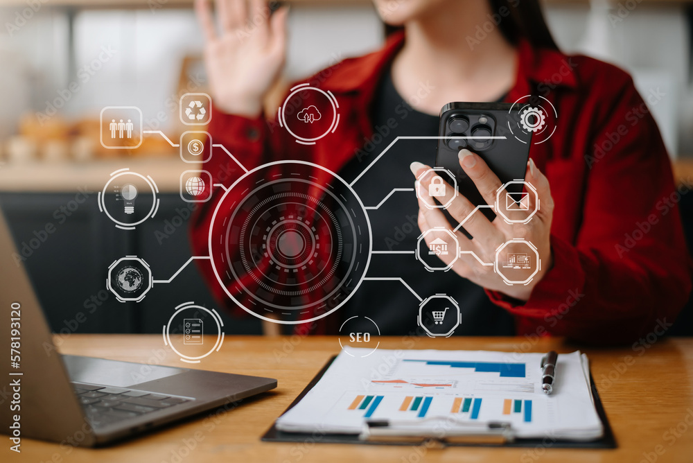 Businesswoman using smartphone and laptop and tablet computer with Digital marketing media in virtual icons interface..