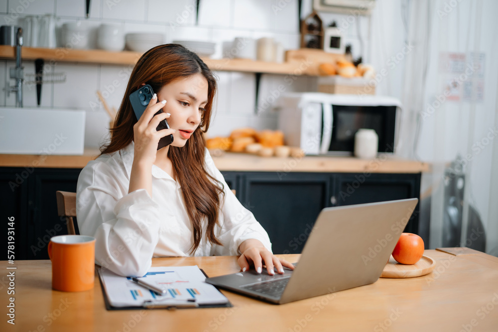  Business woman have the joy of talking on the smartphone, tablet and laptopon the modern office .