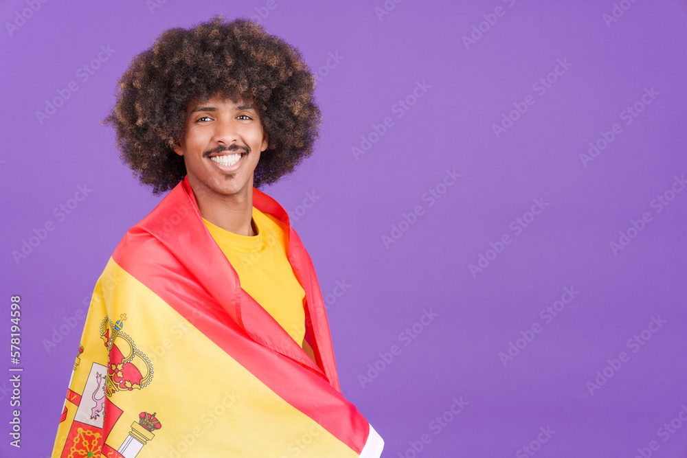Smiling african man wrapping with a spanish flag Smiling african man wrapping with a spanish flag