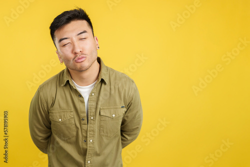 Chinese young man kissing with eyes closed