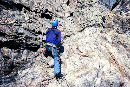 a climber climbs a cliff. extreme sport