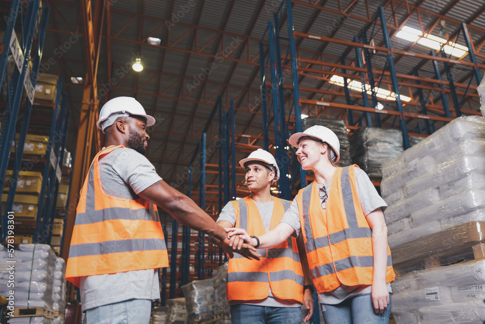 Group worker in safety hat hands together happy celebrate success at warehouse, Logistic inventory teamwork concept Group worker in safety hat hands together happy celebrate success at warehouse, Logistic inventory teamwork concept