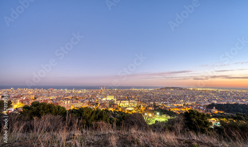 Canvas Print The skyline of Barcelona in Spain at dusk
