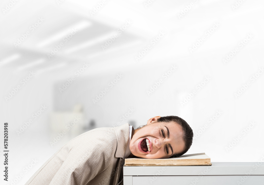 Bored business woman lying on desk Bored business woman lying on desk