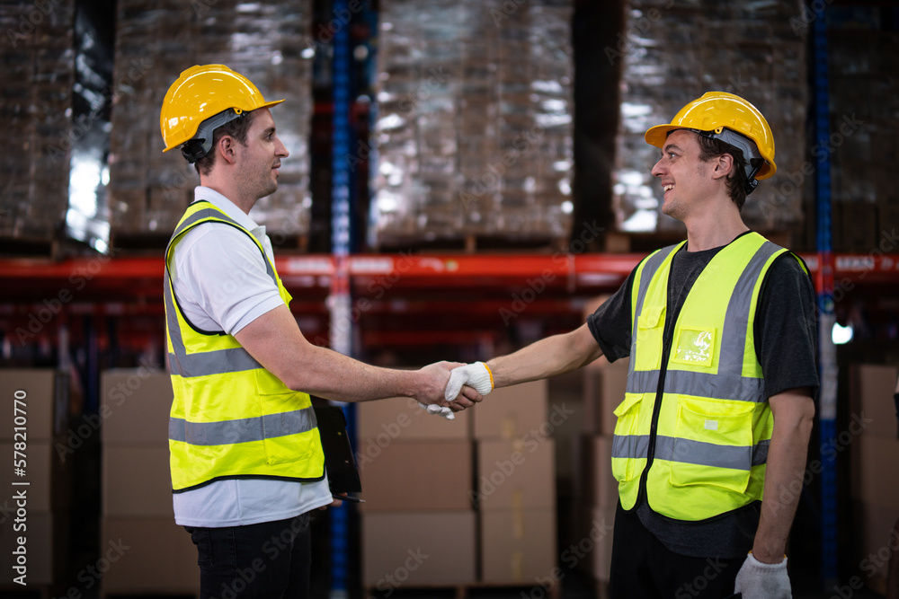 Caucasian warehouse workers showing teamwork and partnership. teamwork at warehouse storage department. Caucasian warehouse workers showing teamwork and partnership. teamwork at warehouse storage department.
