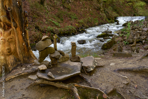 Pagan stone images in mountains, Carpathian whaterfall photo