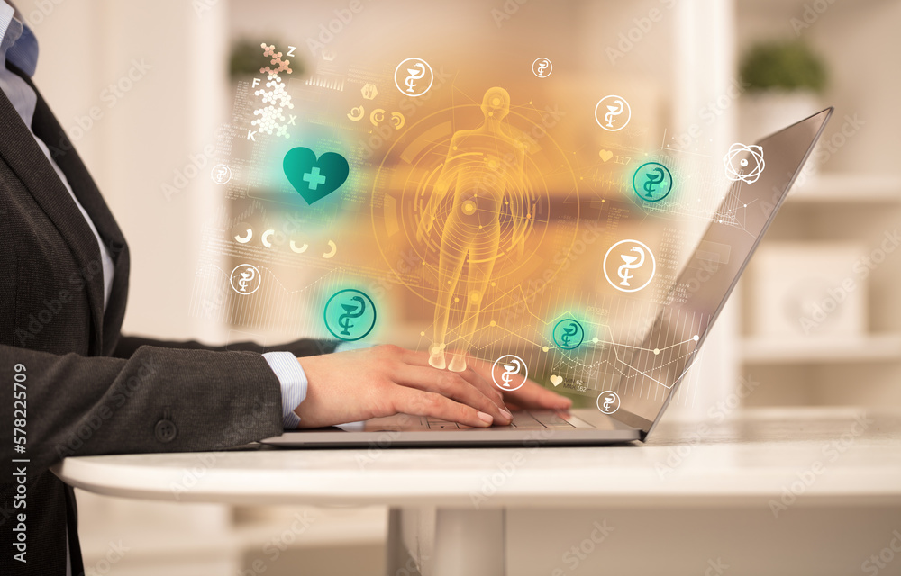 Doctor working on laptop with healthcare concept Doctor working on laptop with healthcare concept