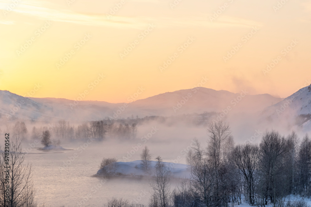 fog in the trees on a mountain river at sunset
