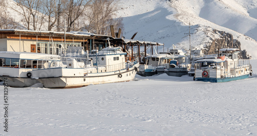 pleasure boats frozen on the river in the ice