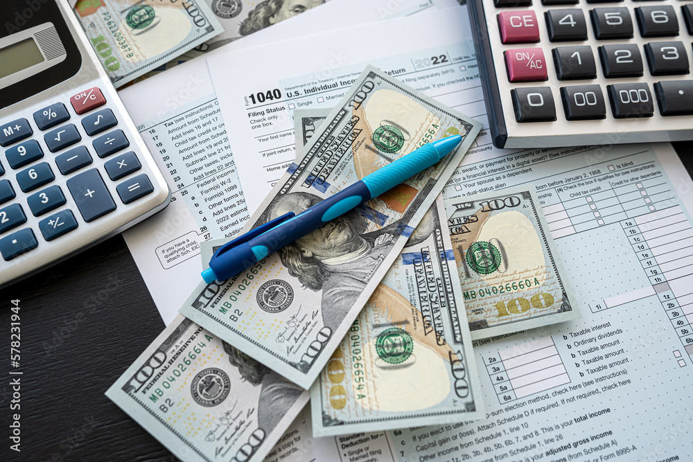 2022 blank 1040 individual tax form with dollar money calculator nad pen on office desk 2022 blank 1040 individual tax form with dollar money calculator nad pen on office desk