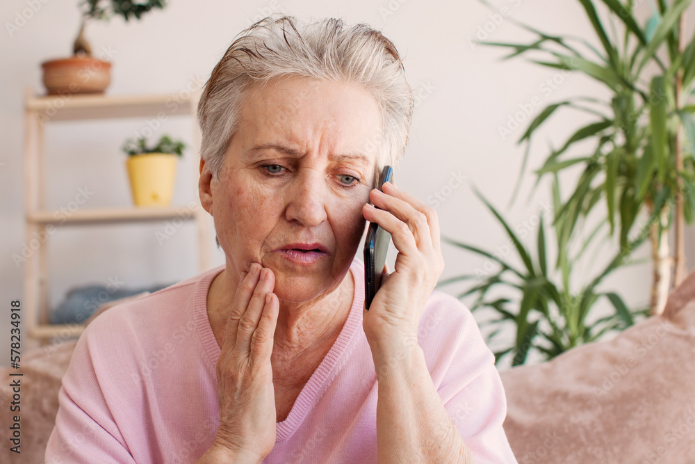 Unhappy stressed mature middle aged woman looking at phone screen Unhappy stressed mature middle aged woman looking at phone screen