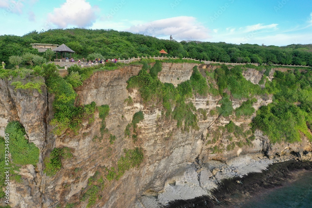 Panorama shot of the spectacular temple complex Pura Luhur in Uluwau on Bali, along the majestic, green-covered cliffs that flow into the sea.