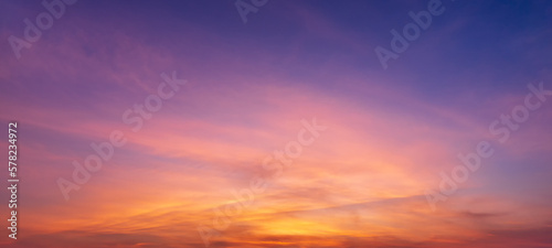 Photos of twilight sky before sunrise or after sunset, clouds fill the sky, panorama  image. orange tones, natural phenomenon background. © c_atta