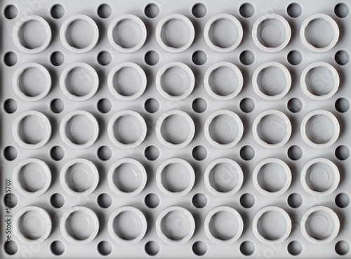 Texture of gray plastic circles. Geometric pattern made of plastic.