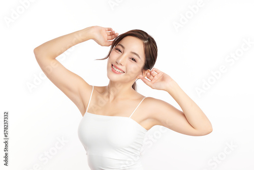 Beautiful Young Asian woman lifting hands up to show off clean and hygienic armpits or underarms on white background, Smooth armpit cleanliness and protection concept