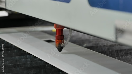 A Laser Cutting Machine Cutting a Piece of White Perspex photo