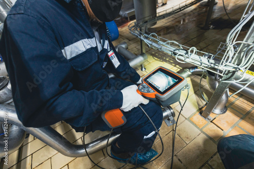 Fotografía Male worker inspection steel tube video probe construction tank stainless