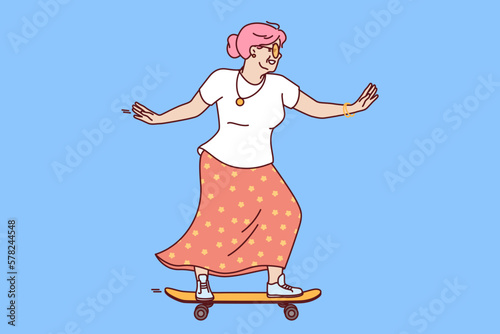 Older woman rides skateboard wanting to stay young and act like teenager heading to skatepark. Elderly woman with skateboard enjoys retirement age and lack of work responsibilities