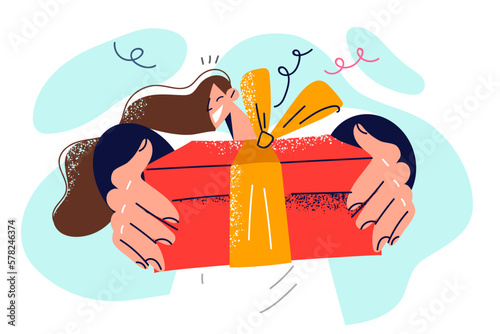 Happy woman showing off cool gift received from boyfriend or friends in honor birthday party