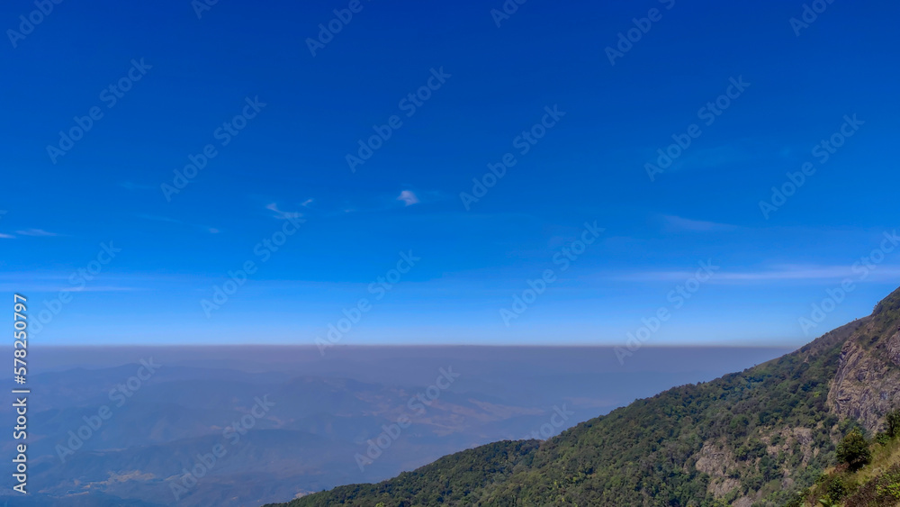 View of hill forest and blue sky.