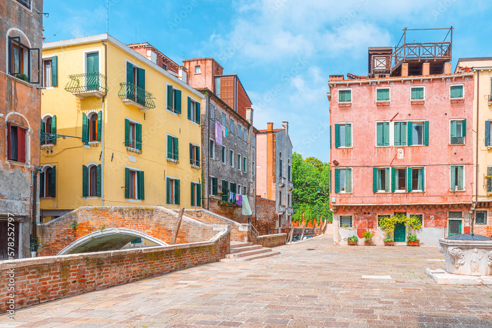 Beautiful view of old square with colorful buildings and bridge in old town of Venice, Veneto, Italy