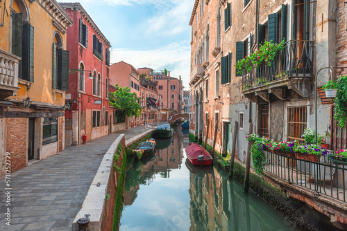 Fototapeta Naklejka Na Ścianę i Meble -  Venice, Italy. View on Venetian medieval street with old colorful buildings and bridge over water canal with boats