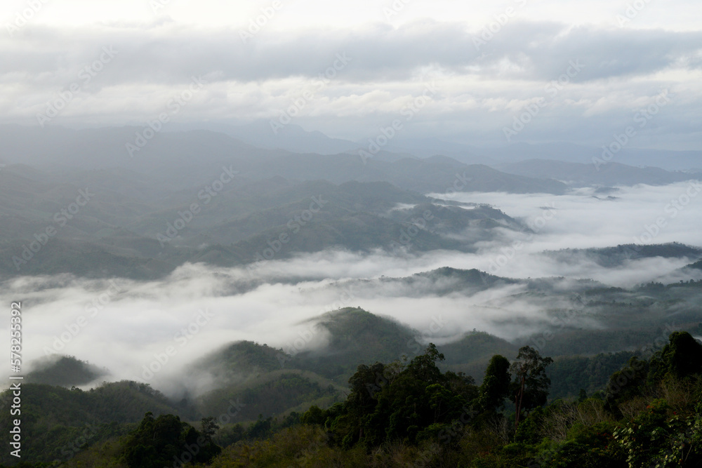 Landscape Green nature fog and misty cover around mountain valley seen from Skywalk Aiyerweng Famous landmark in Betong Yala southern thailand - in the morning - Travel and Sighseeing South east Asia 