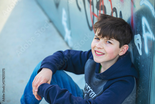 Above view of young teen with casual clothes while sitting on ground