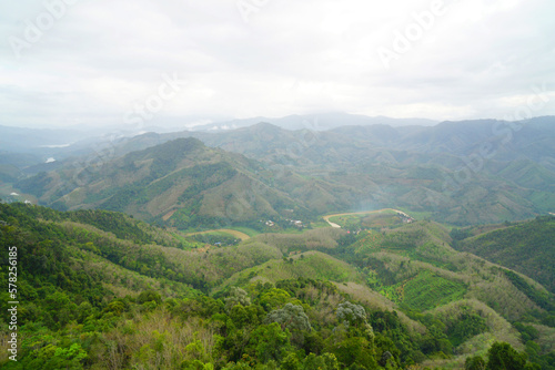 Landscape Green nature fog and misty cover around mountain valley seen from Skywalk Aiyerweng Famous landmark in Betong Yala southern thailand - in the morning - Travel and Sighseeing South east Asia 