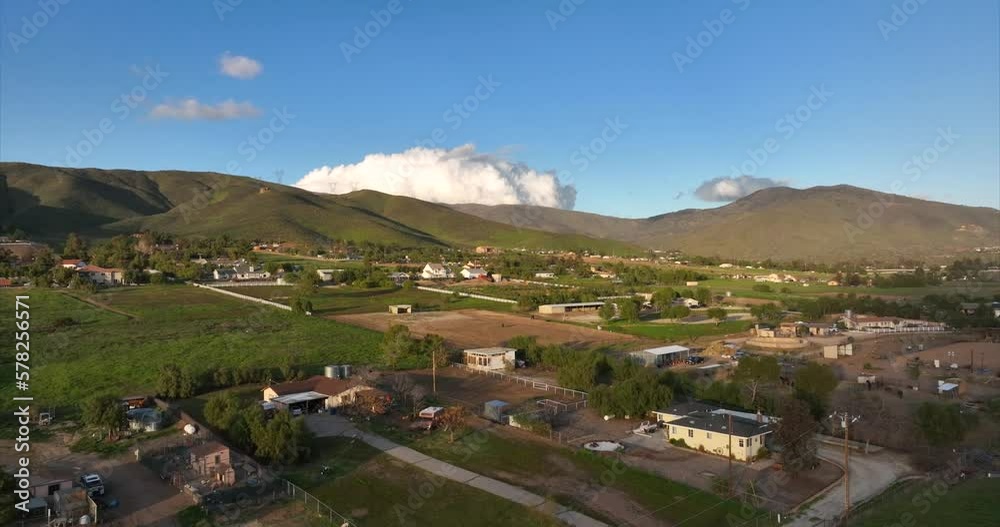 Ascending aerial view of rural farmland countryside in rolling green hills Ascending aerial view of rural farmland countryside in rolling green hills
