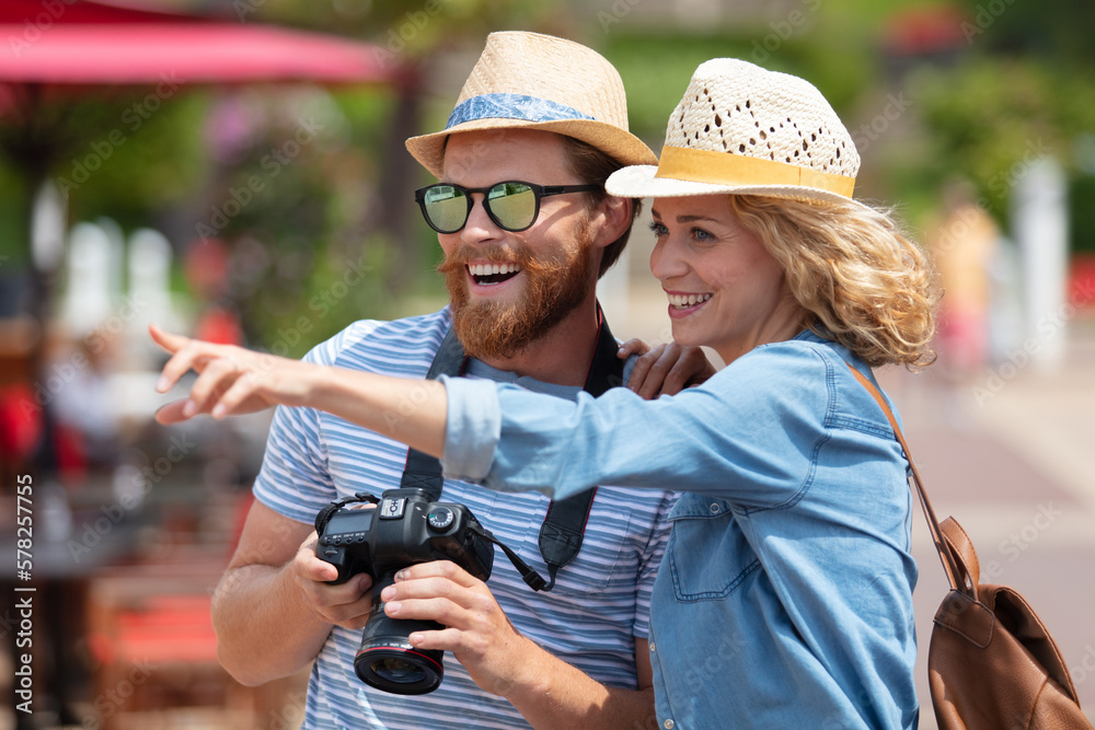 man photographer takes pictures with woman in street man photographer takes pictures with woman in street