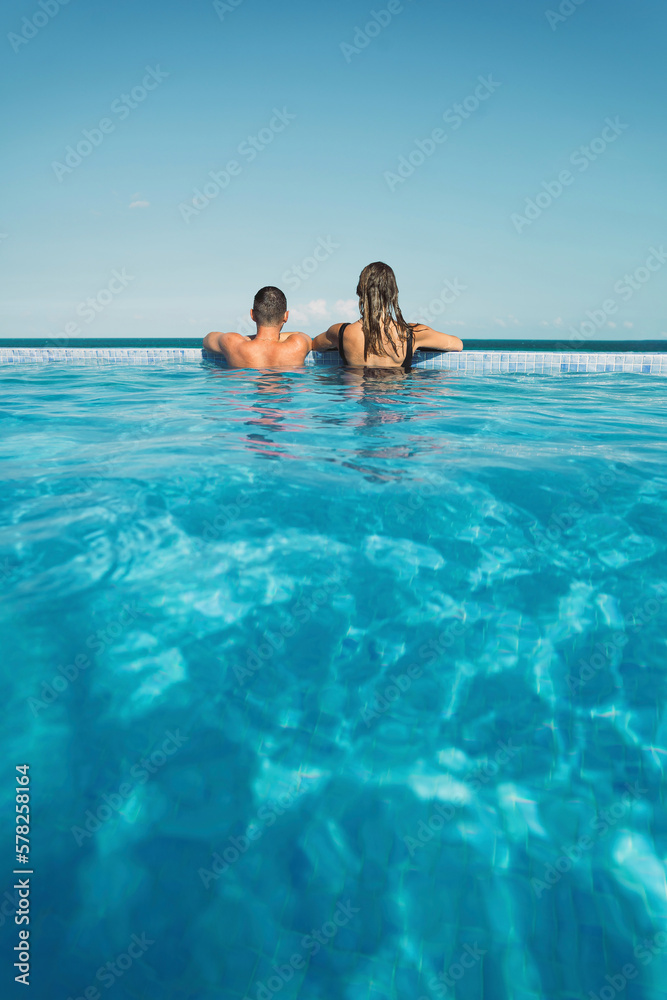 Couple spending vacation in swimming pool Couple spending vacation in swimming pool