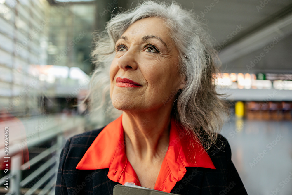 Mature businesswoman with gray hair at station Mature businesswoman with gray hair at station
