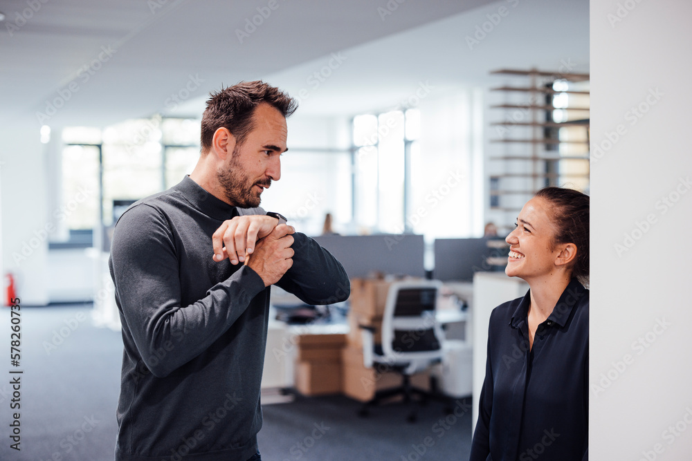 Businessman talking with colleague in office Businessman talking with colleague in office