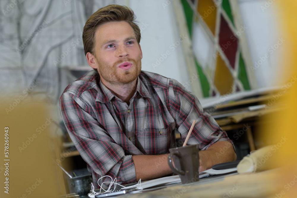 young handsome designer working at modern coworking studio young handsome designer working at modern coworking studio