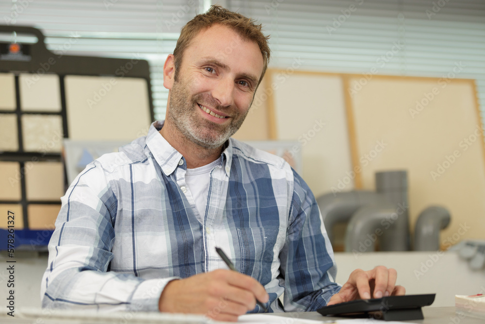 happy man showing a calculator happy man showing a calculator