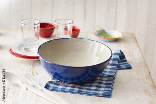 Empty bowl on checked dish towel