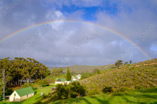 South Africa, Western Cape, Malgas, Rainbow arching over small secluded village photo