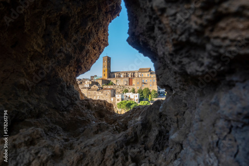 Italy, Lazio, Sutri, Cathedral of Santa Maria Assunta seen through hole in rock wall photo