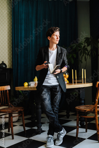 Director holding book standing at film set