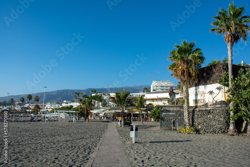 Torviscas Playa with sand beach, palm trees and mountains in Costa Adeje, Spain