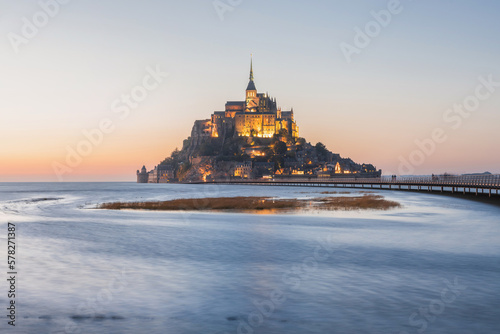 Sunset view of Le Mont Saint Michel abbey on the island in high tide, Normandy, Northern France, Europe