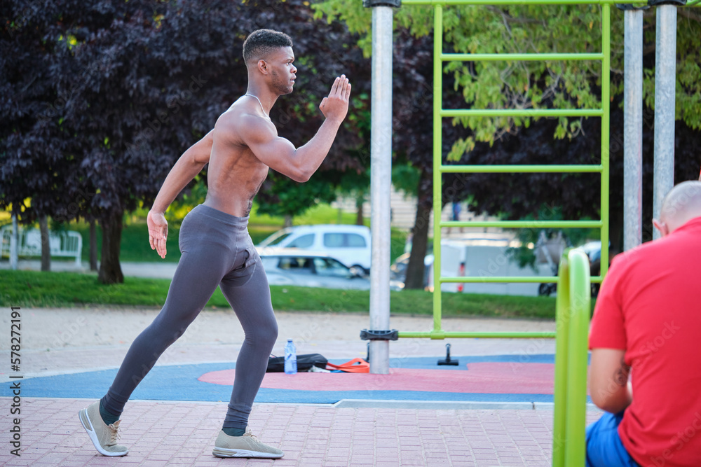 Young fit shirtless black man ready to run outdoors on sunny summer day. Fitness and sport lifestyle. Young fit shirtless black man ready to run outdoors on sunny summer day. Fitness and sport lifestyle.