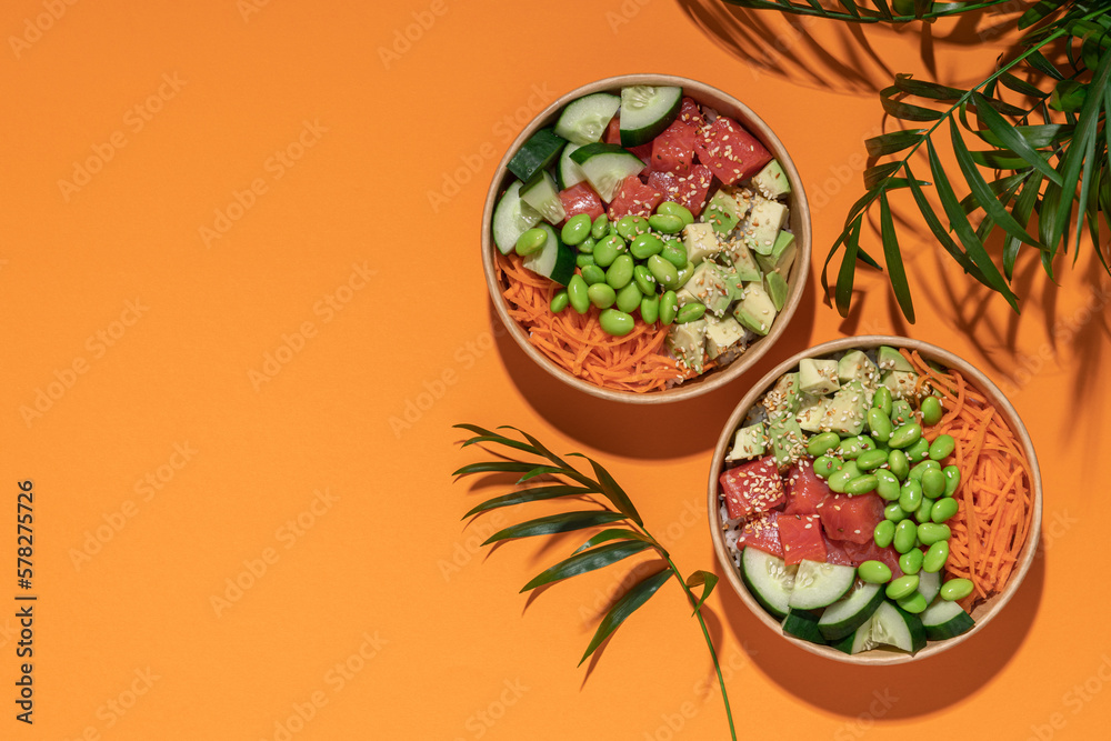 Poke bowl in cardboard containers on bright sunny background. Summer mood concept. Healthy food delivery Poke bowl in cardboard containers on bright sunny background. Summer mood concept. Healthy food delivery