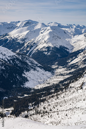 View of the Tatra Mountains in winter from the peak of Kasprowy Wierch. Sunny weather during a hike in the mountains.