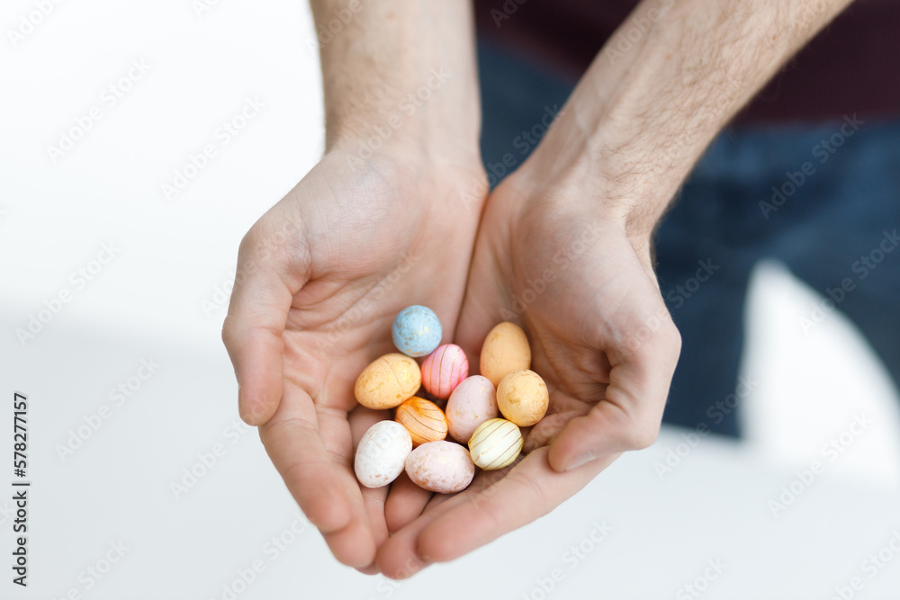 Easter toys. Easter toys in the hands of a man. Blurred background. Easter holiday concept background. Easter toys. Easter toys in the hands of a man. Blurred background. Easter holiday concept background.